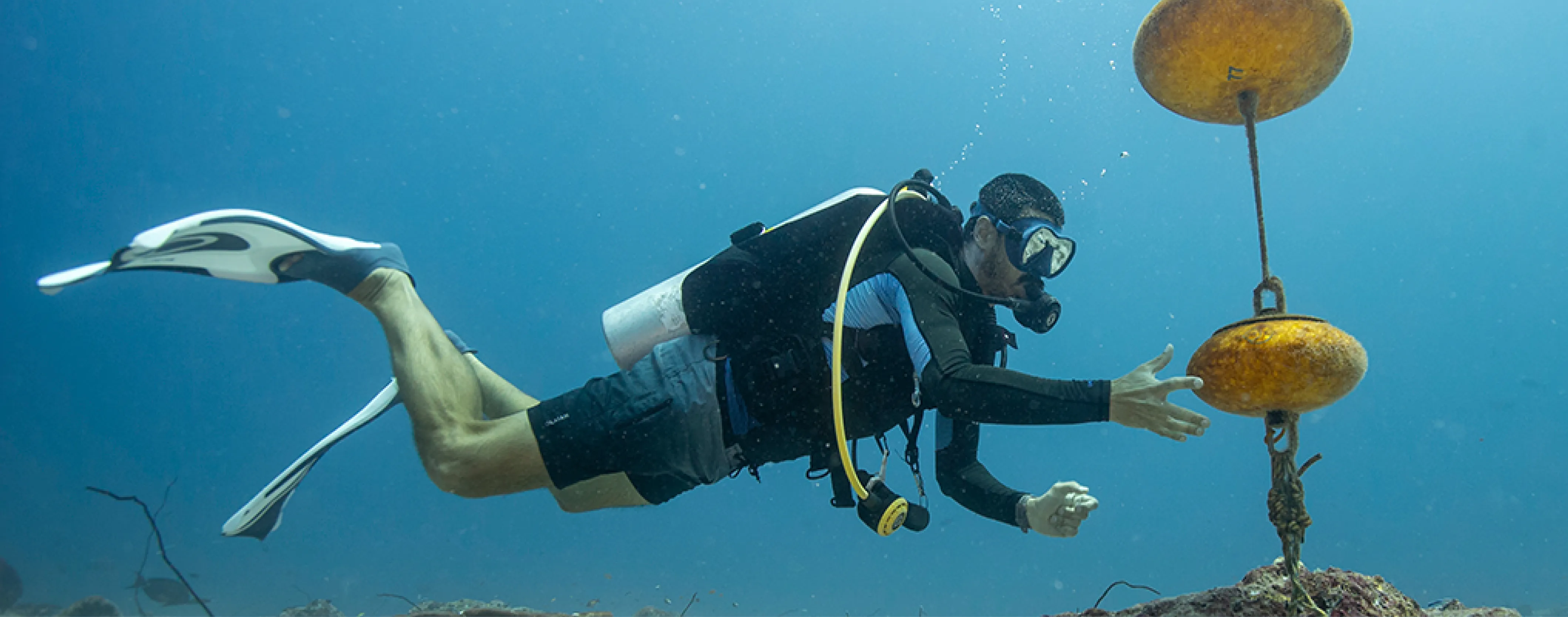 A diver secures a Nortek ADCP under water